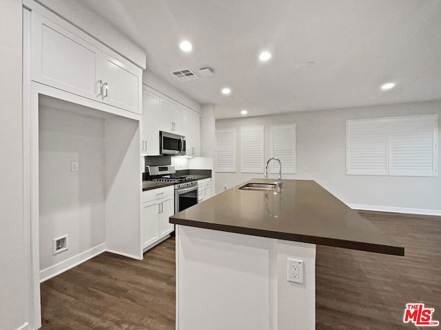 kitchen featuring sink, white cabinets, an island with sink, and appliances with stainless steel finishes