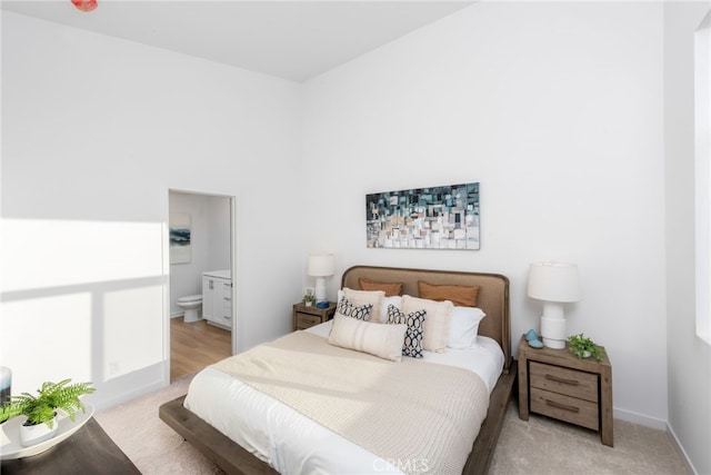 carpeted bedroom with connected bathroom