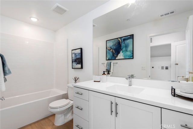 full bathroom featuring hardwood / wood-style floors, vanity, bathtub / shower combination, and toilet