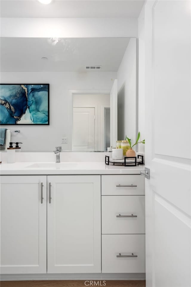 bathroom with wood-type flooring and vanity