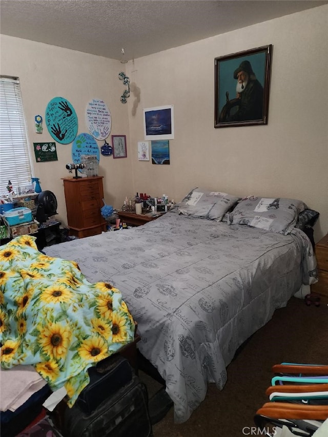 carpeted bedroom with a textured ceiling