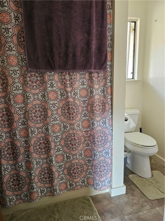 bathroom with tile patterned floors and toilet