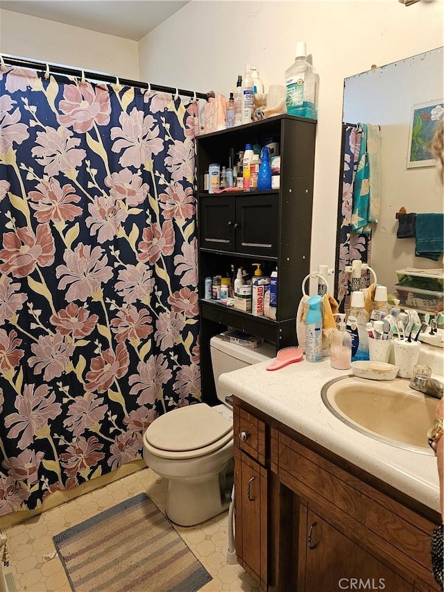 bathroom featuring vanity and toilet