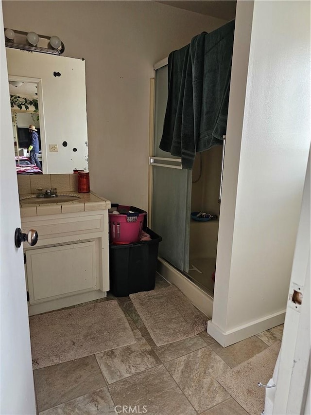 bathroom with vanity and a shower with shower door