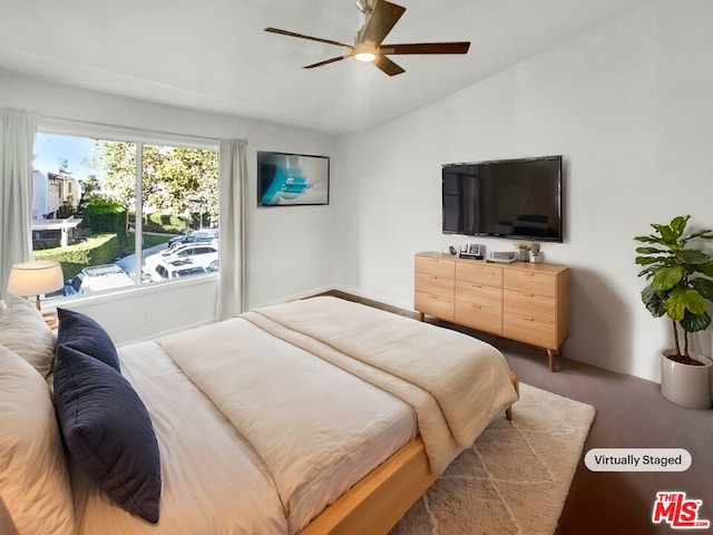 carpeted bedroom featuring ceiling fan and vaulted ceiling