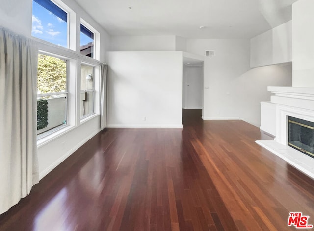 unfurnished living room featuring dark hardwood / wood-style flooring