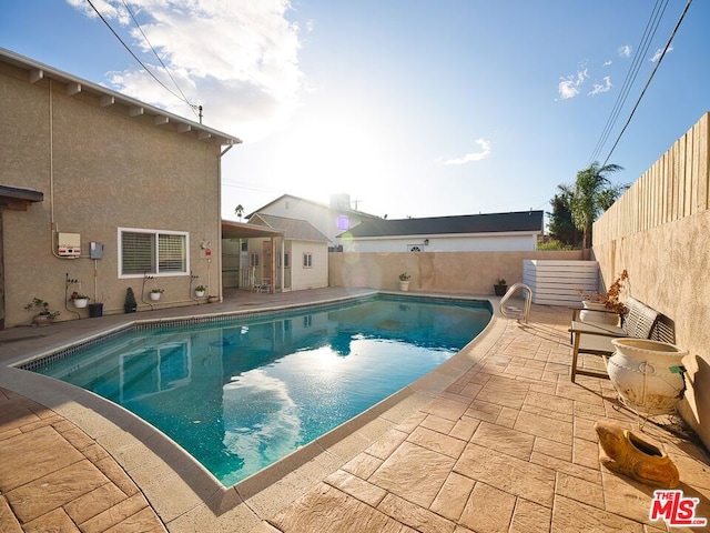 view of swimming pool with a patio