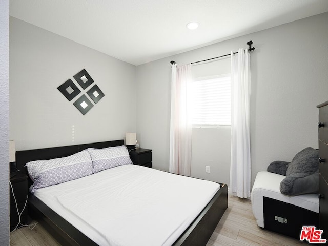 bedroom with light wood-type flooring