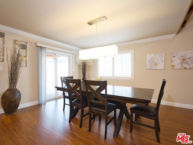 dining area featuring ornamental molding, a wealth of natural light, and dark wood-type flooring