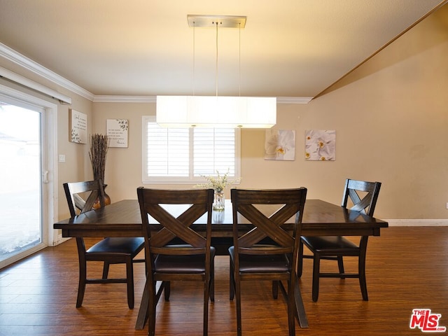 dining space featuring crown molding and dark hardwood / wood-style flooring