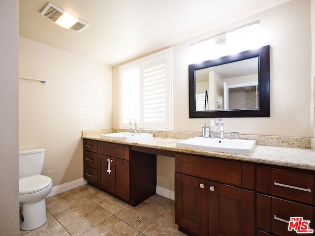 bathroom with tile patterned floors, vanity, and toilet