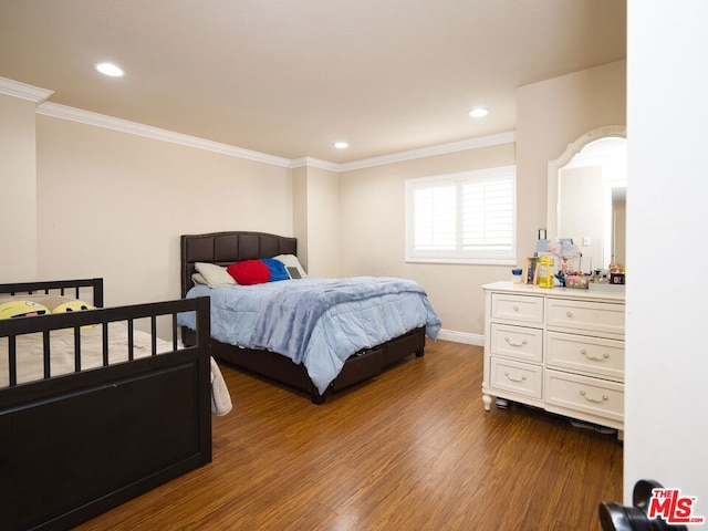 bedroom with dark hardwood / wood-style floors and ornamental molding