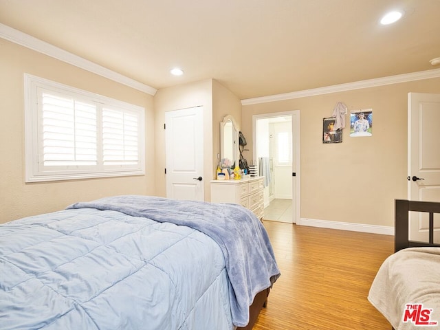 bedroom featuring ornamental molding and light wood-type flooring