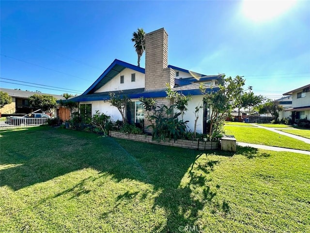 view of home's exterior with a yard