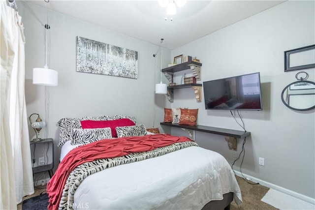 bedroom featuring ceiling fan and carpet