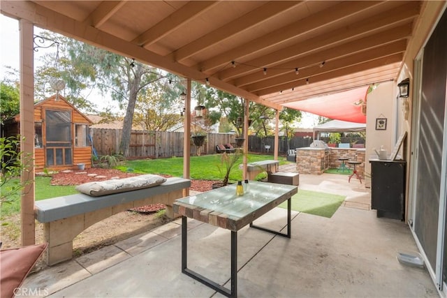 view of patio with an outbuilding and area for grilling