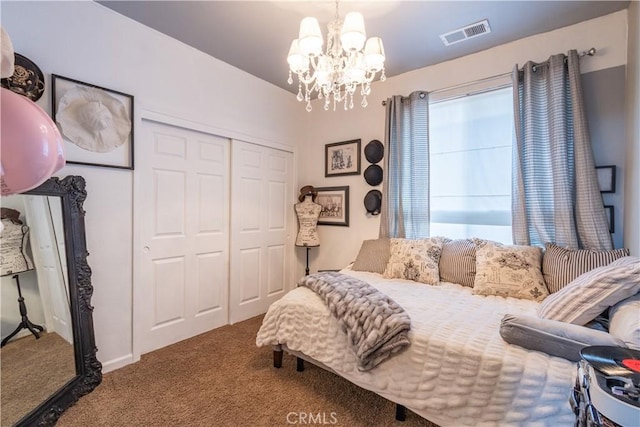 carpeted bedroom featuring a closet, a chandelier, and multiple windows