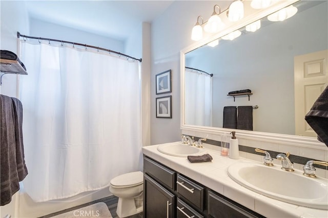 bathroom with toilet and vanity