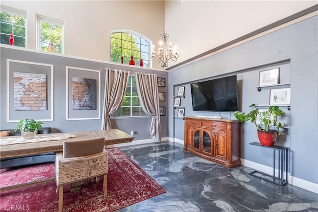 living room with a high ceiling, a wealth of natural light, and an inviting chandelier