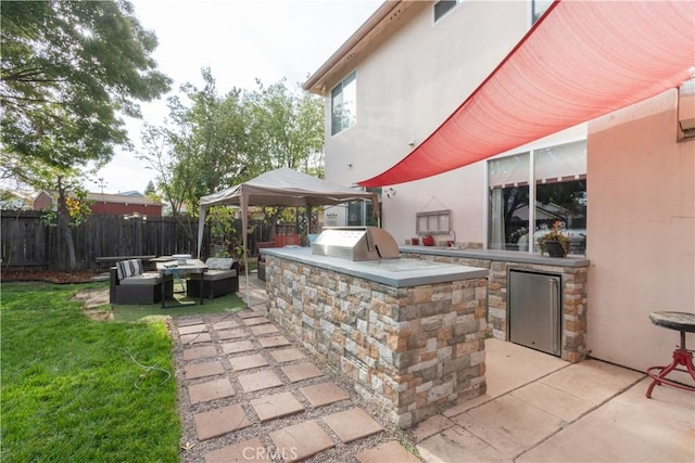 view of patio featuring an outdoor kitchen, a gazebo, and area for grilling