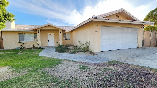 single story home featuring a front yard and a garage