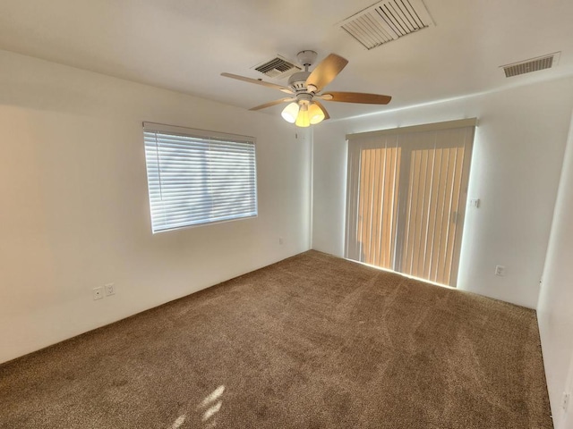 unfurnished room featuring carpet and ceiling fan