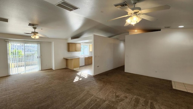 unfurnished living room featuring carpet, ceiling fan, and a wealth of natural light