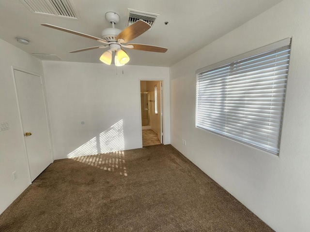 carpeted empty room featuring ceiling fan