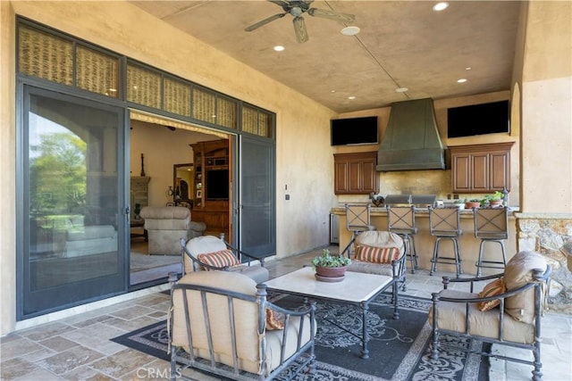 view of patio with a bar and ceiling fan