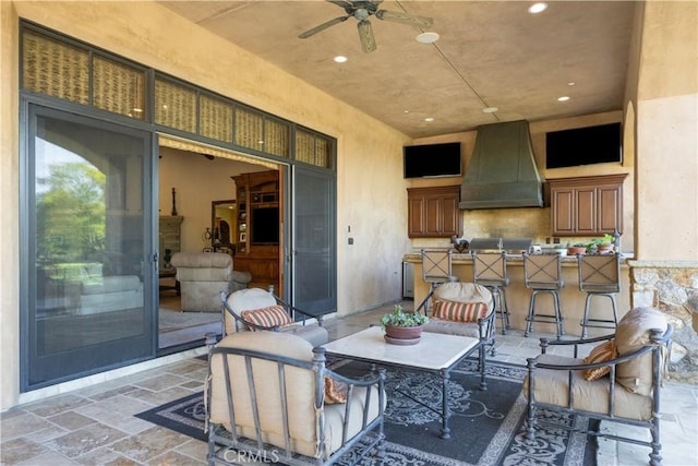 view of patio featuring ceiling fan and an outdoor bar