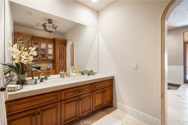 bathroom featuring visible vents, tile patterned floors, baseboards, and vanity