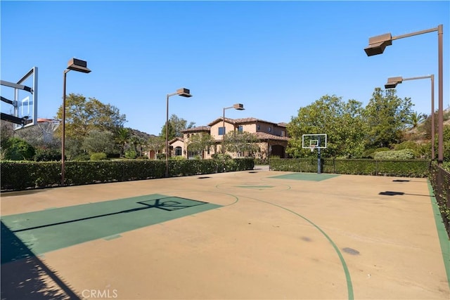 view of basketball court featuring fence and community basketball court