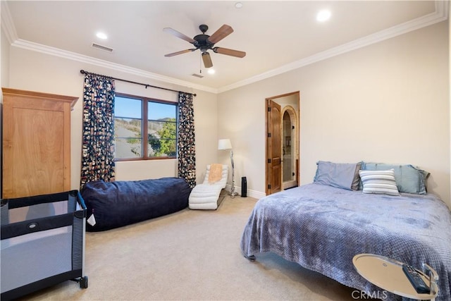 carpeted bedroom with ceiling fan and crown molding