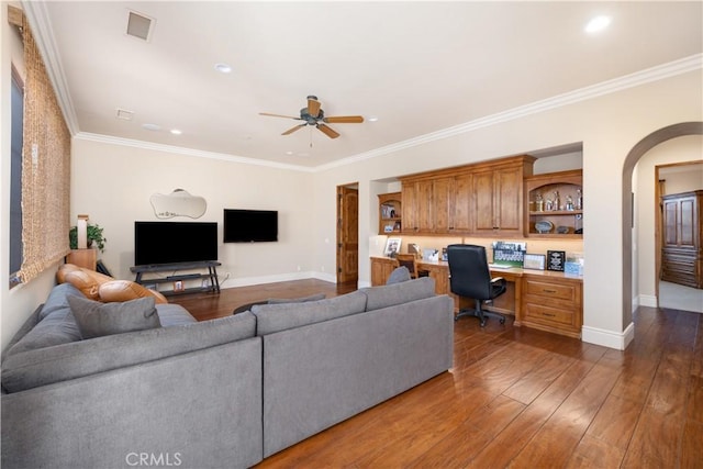 living room featuring crown molding, dark wood-type flooring, and built in desk