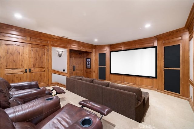 home theater room featuring light carpet, visible vents, recessed lighting, a decorative wall, and wooden walls