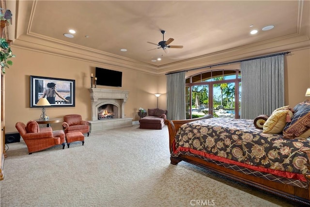 bedroom with access to exterior, carpet, ornamental molding, ceiling fan, and a fireplace