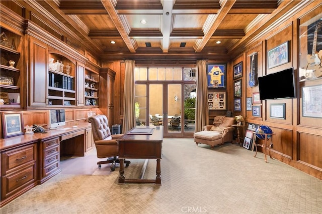 carpeted home office featuring beam ceiling, wood walls, coffered ceiling, and ornamental molding