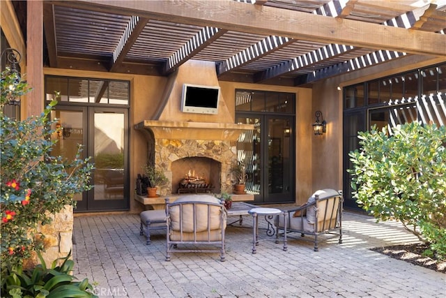 view of patio / terrace with an outdoor stone fireplace