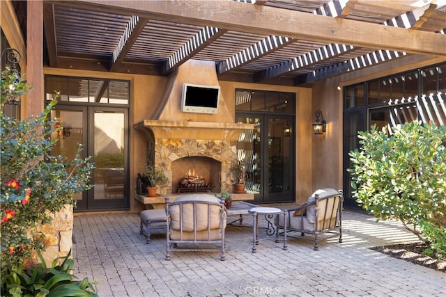 view of patio / terrace featuring a pergola and an outdoor stone fireplace