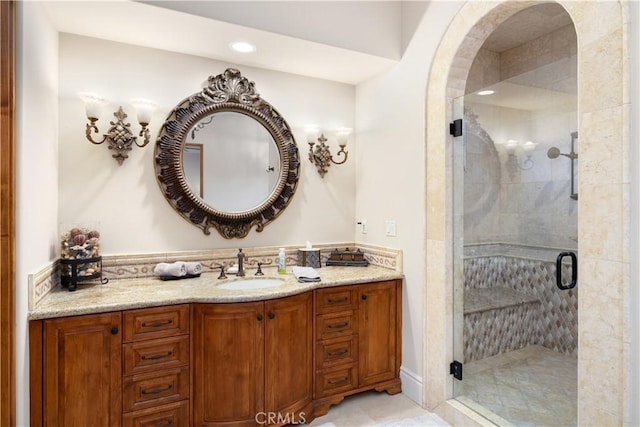 bathroom featuring vanity, tile patterned floors, and walk in shower