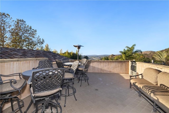 view of patio / terrace with a mountain view and an outdoor hangout area