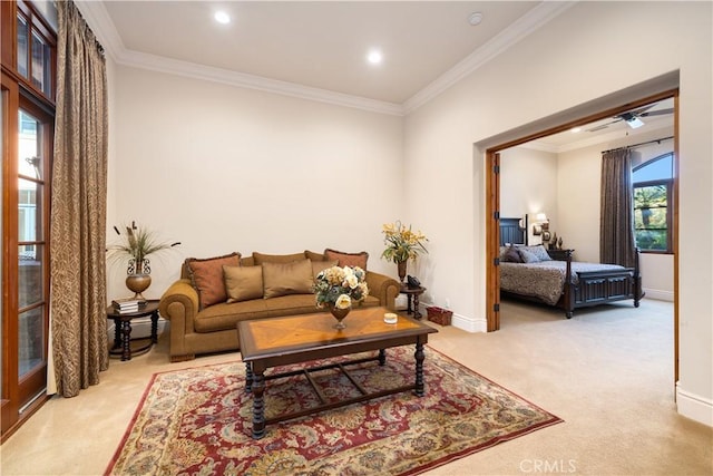carpeted living room featuring ceiling fan, baseboards, crown molding, and recessed lighting