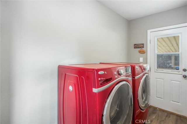 laundry area featuring dark hardwood / wood-style flooring and washing machine and clothes dryer