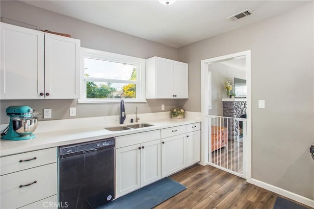 kitchen with dishwasher, white cabinets, dark wood-type flooring, and sink