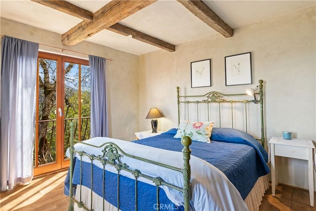 bedroom with french doors, beamed ceiling, and hardwood / wood-style flooring