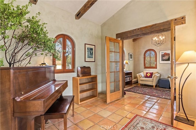 miscellaneous room featuring vaulted ceiling with beams, french doors, light tile patterned floors, and an inviting chandelier