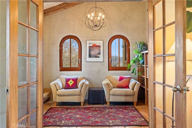 sitting room with french doors, lofted ceiling with beams, and a healthy amount of sunlight