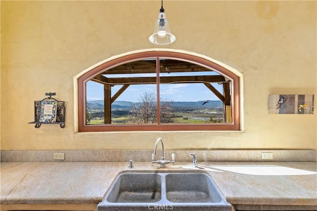 kitchen featuring a mountain view, sink, and decorative light fixtures