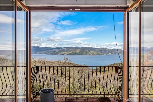 balcony with a water and mountain view