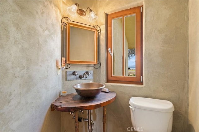 bathroom with toilet and sink